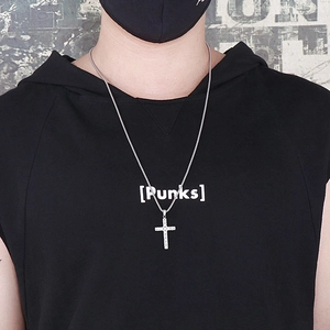 Gros plan d'un collier avec pendentif croix en acier argenté et pierres sur un mannequin