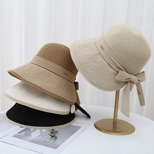 Elegant straw sun hat with back split, oversized bow, and unique fabric stitching design