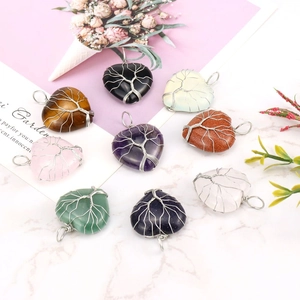 Close-up of heart-shaped natural stone pendants with silver tree of life wire wrapping