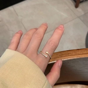 Detailed view of an adjustable gold star ring with sparkling cubic zirconia on a hand