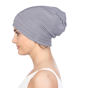 Women's gray pleated headscarf turban with elastic knitted texture on white background