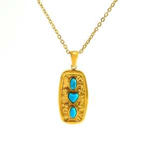 French vintage gold-plated stainless steel necklace with turquoise heart pendant on white background