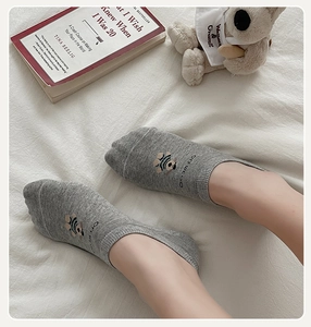 Detail of grey low-cut cotton socks with cute bear embroidery and OFF WE GO text