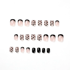 Short square press-on nails set with black French tips and heart patterns on pink base