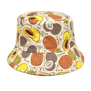 Close-up of tropical fruit prints with pineapple and coconut on white bucket hat