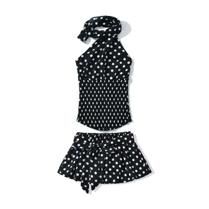 Polka dot ruffled two-piece set featuring a halter top and tiered skirt with bow tie