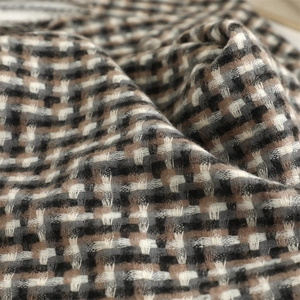 Macro shot of thick retro plaid scarf showing woven texture and soft winter fibers