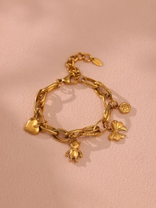 Detail of 18k gold plated stainless steel bracelet with heart and butterfly charms