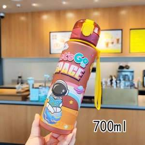 700ml brown astronaut plastic water bottle with carry strap shown in hand at a cafe
