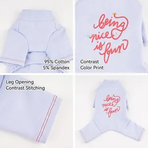 Light purple cotton dog onesie with 'being nice is fun' print and contrast stitching