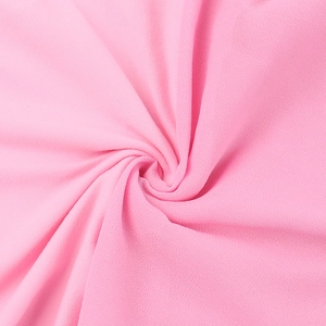 Detailed macro view of pink fabric texture with fine grain and elegant draping quality