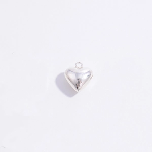 Polished S925 sterling silver heart pendant macro detail on a white background