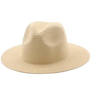 Close-up of beige woven straw Fedora hat showing detailed texture and classic pinched crown