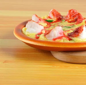 Macro shot of realistic fake pizza prop with shrimp toppings on a rustic wooden tray