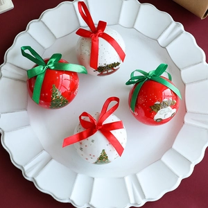 Set of 4 red and white glossy Christmas tree ornaments with ribbons and festive patterns