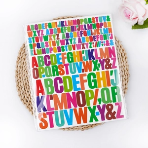Macro shot of colorful alphabet stickers in mixed sizes on a woven mat background