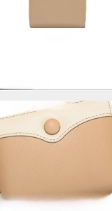 Detail view of bi-color pebbled leather wallet with button closure and rear perspective