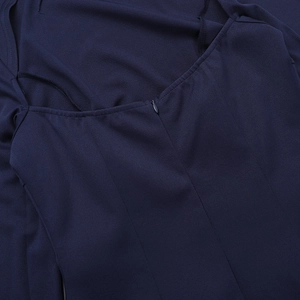 Close-up detail of invisible zipper and fine stitching on a navy blue long sleeve dress