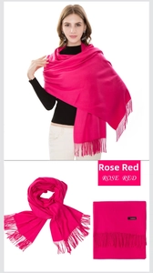 Detail of rose red cashmere scarf featuring soft texture and elegant fringe tassels
