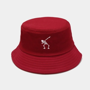 Close-up of white skeleton embroidery on a burgundy cotton canvas bucket hat