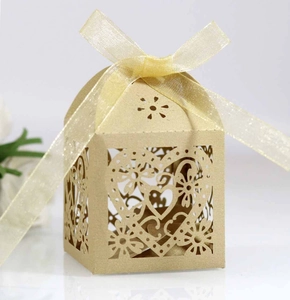 Macro view of champagne gold laser-cut heart pattern and premium pearl paper texture