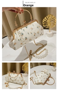 Detail of white lace shell bag with orange rose embroidery and pearl chain strap