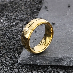 Close-up of golden hammered texture and polished finish on a titanium steel ring for men