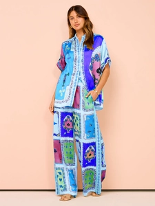 Detail view of the colorful card pattern on the silky satin two-piece casual set