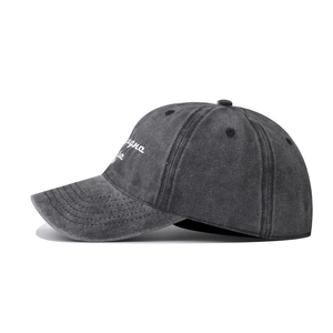 Detail of gray washed cotton baseball cap featuring side embroidery and contrast stitching