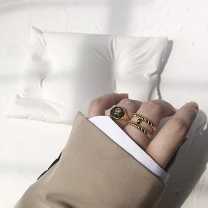 Detail of vintage 18K gold plated stackable rings with rose engraving and twisted rope design