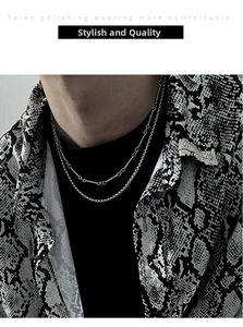 Close-up of double-layered silver titanium steel necklace on model with street style