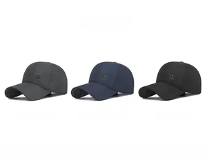 Three colors of quilted winter baseball caps with ear protection in grey, navy, and black