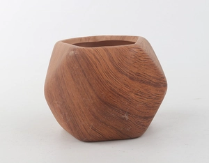 Macro detail of geometric ceramic succulent pot with dark brown wood grain finish