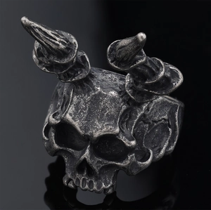 Macro view showing vintage punk style horned skull ring with antique silver finish