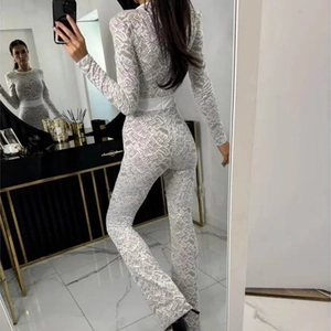 Detailed back view of white lace long sleeve jumpsuit with waist belt and hollow pattern
