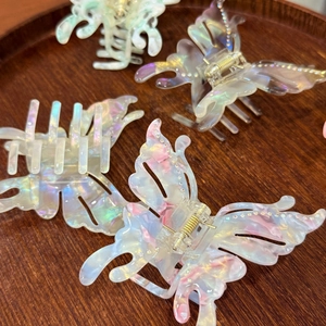 Detailed macro view of colorful acetate butterfly hair claw clips with sparkling rhinestones