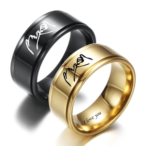 Detail of I Love You engraving inside gold and black stainless steel couple rings