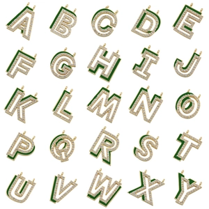 Macro shot of 26 green enamel gold-plated letter pendants with sparkling rhinestones