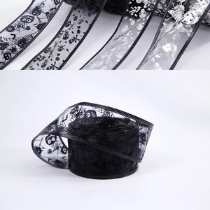 Close-up of Halloween ribbons with skull, spider web and bat patterns in black and silver