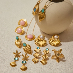 Golden ocean-themed jewelry set featuring starfish and seashell motifs with colorful pearls