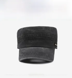 Close-up of washed cotton flat top military cap with metal brand tag and reinforced brim