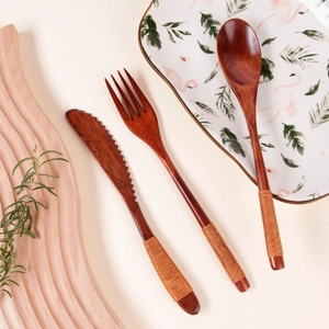 Detail of wooden cutlery set with woven twine handles and natural wood grain finish