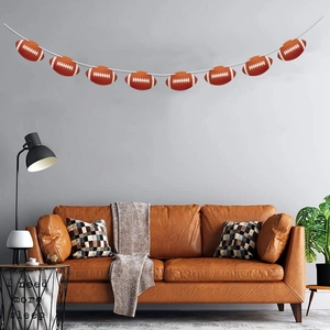 American football themed party banner hanging above a sofa for sports event decoration