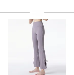 Detail of high waisted yoga pants with side slit and matching bowknot in light purple