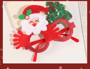 Detail of Christmas glasses with red glitter frame and felt Santa Claus decoration