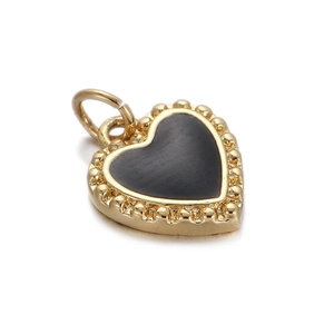 Detailed view of a golden heart-shaped pendant with black inlay for DIY jewelry making