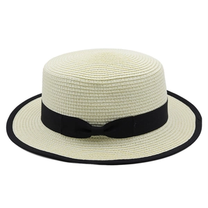 Classic boater straw hat with black bow and contrast piping for summer beach holidays