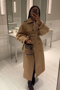 Mirror selfie showing the fit of a khaki double-breasted trench coat with waist belt