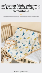 Detail of A-class pure cotton baby towel with dinosaur prints on a wooden crib