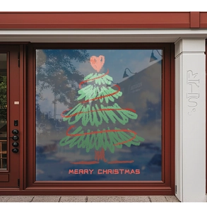 Detail of Christmas tree window sticker with heart topper on a glass shop storefront